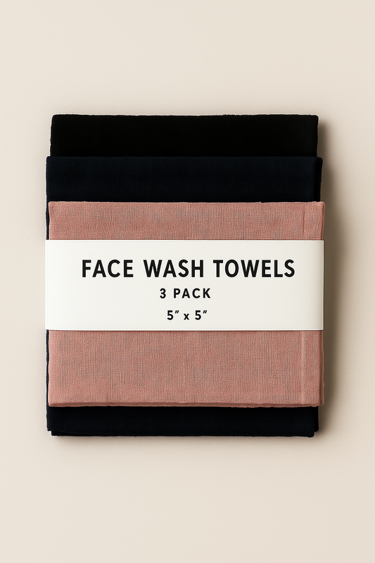 Three face wash towels in black, navy, and pink with a label on a beige background